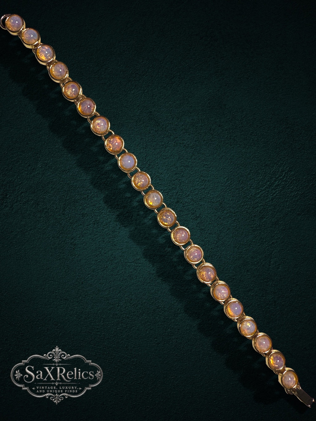 My Store vintage-inspired gold-tone link bracelet featuring luminous cabochon-cut faux opal stones on dark background