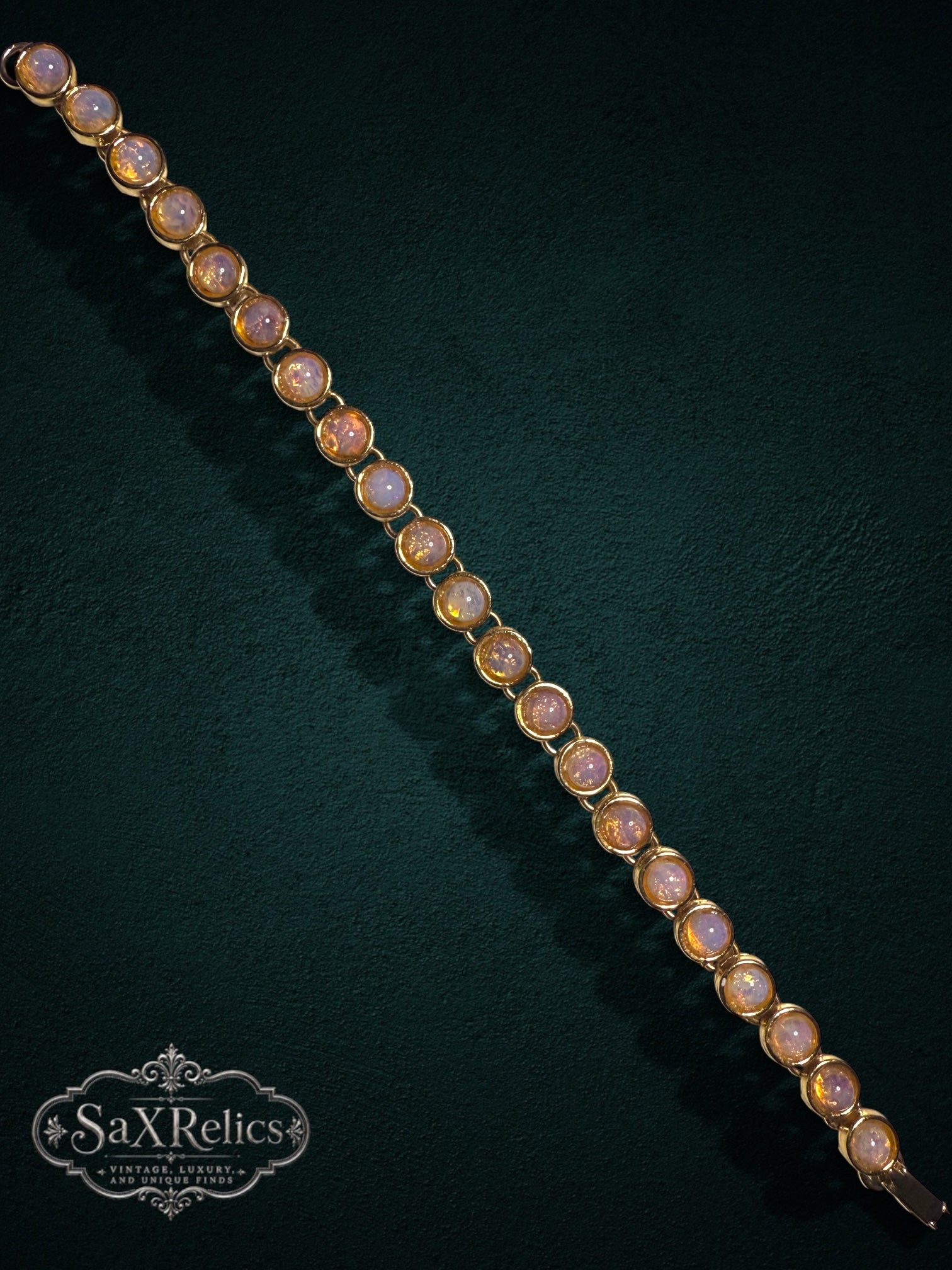 My Store vintage-inspired gold-tone link bracelet featuring luminous cabochon-cut faux opal stones on dark background