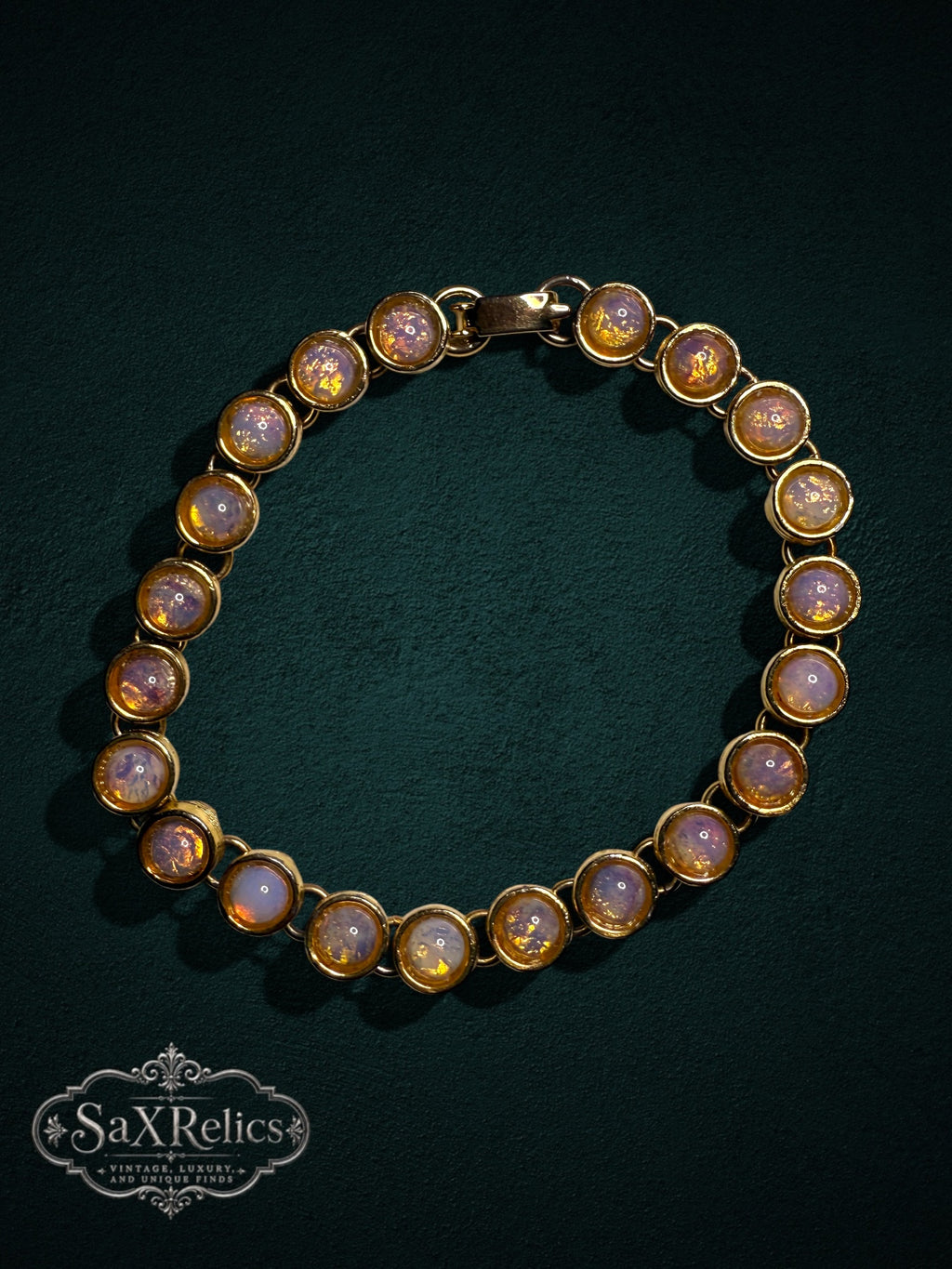 My Store vintage-inspired gold-tone link bracelet featuring iridescent cabochon faux opal stones on a dark background.