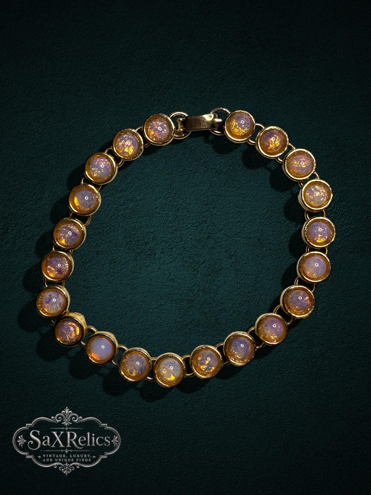 My Store vintage-inspired gold-tone link bracelet featuring iridescent cabochon faux opal stones on a dark background.