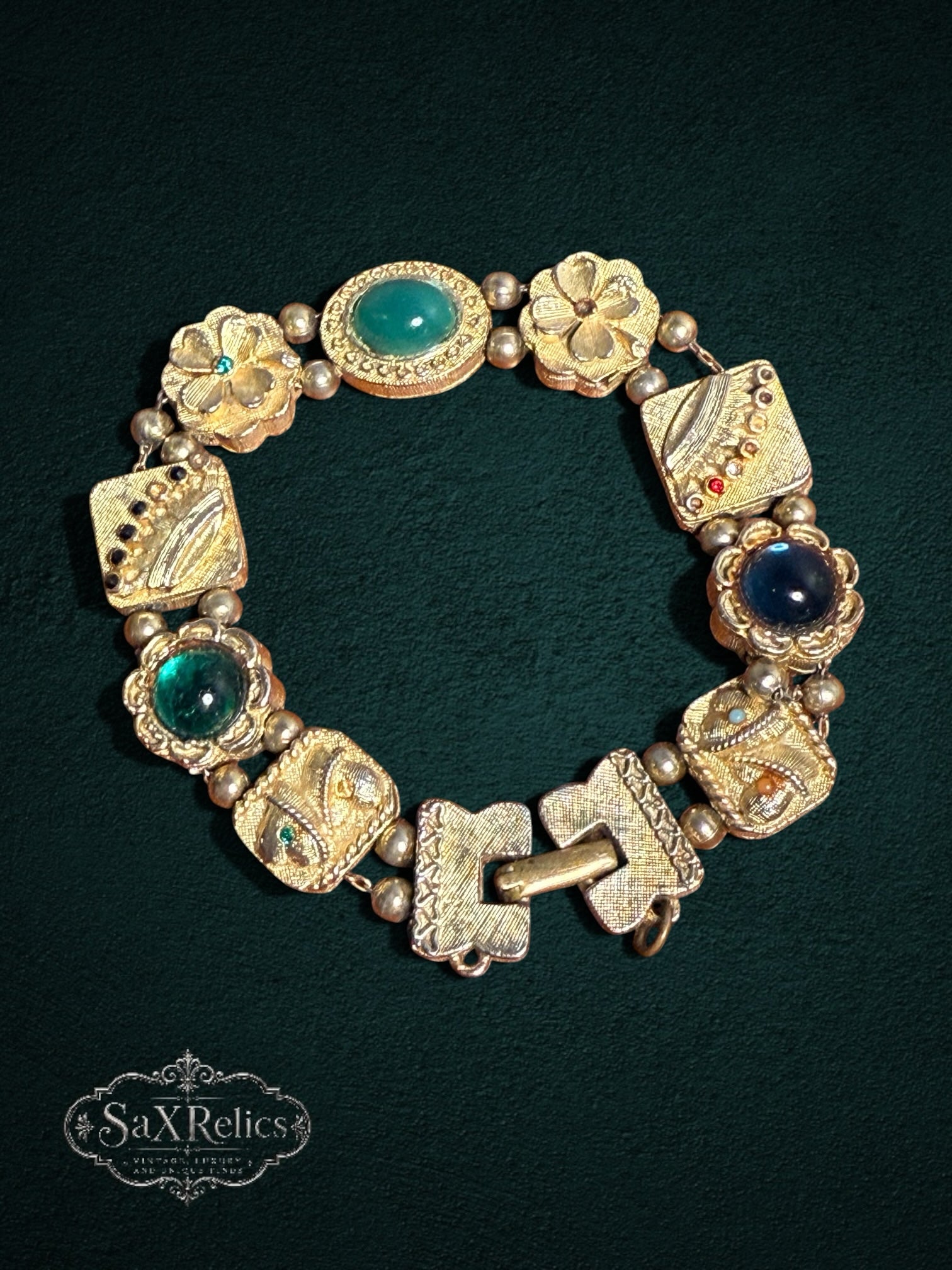 My Store vintage ornate gold-tone link bracelet with emerald green and blue cabochon stones and floral motifs.