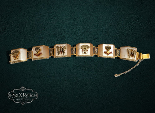 My Store vintage link bracelet featuring cream resin panels, gold-tone filigree, butterfly motifs, and portrait busts.