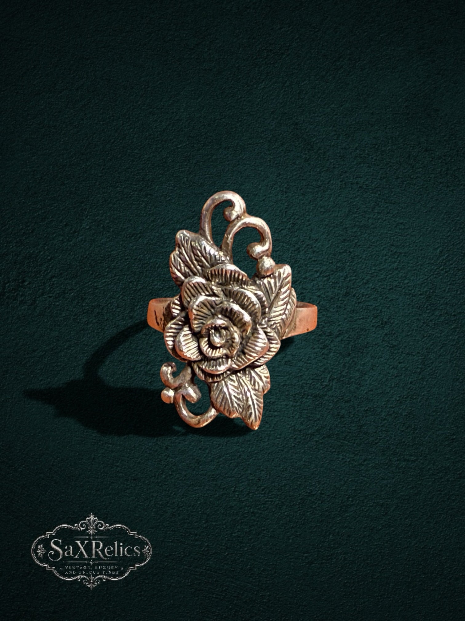 My Store vintage-inspired rose statement ring with intricate floral petals and leaf accents in a metallic finish.