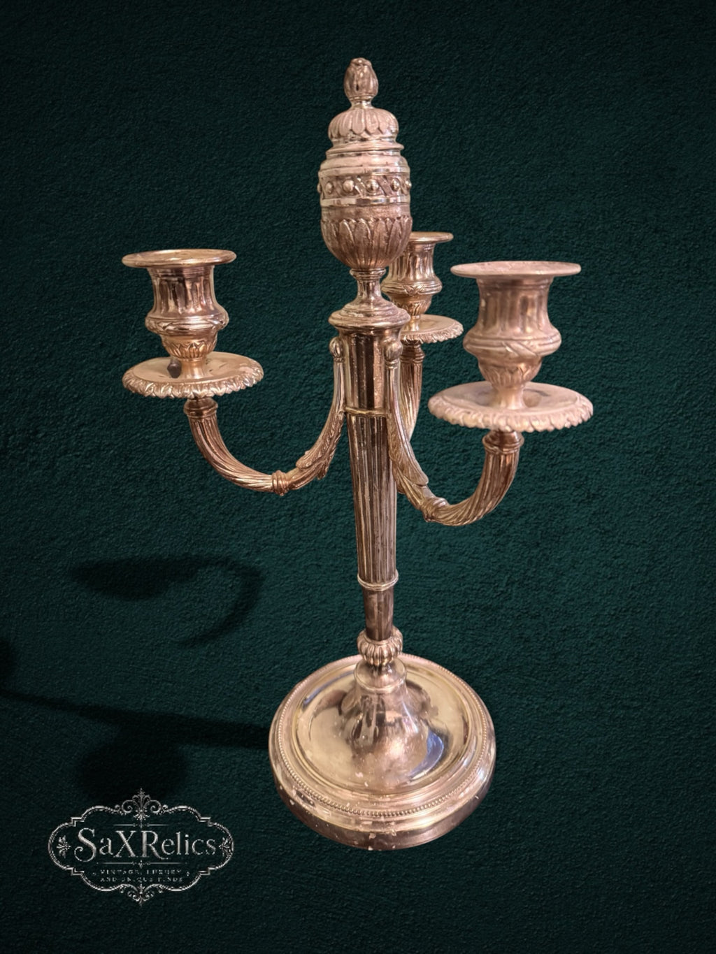 My Store vintage silver-plated three-light candelabra with ornate fluted stem and intricate decorative detailing.