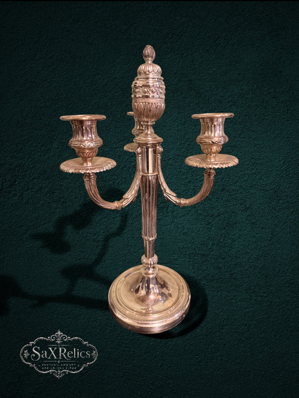 My Store vintage silver-plated three-light candelabra with ornate fluted stems and intricate decorative detailing.
