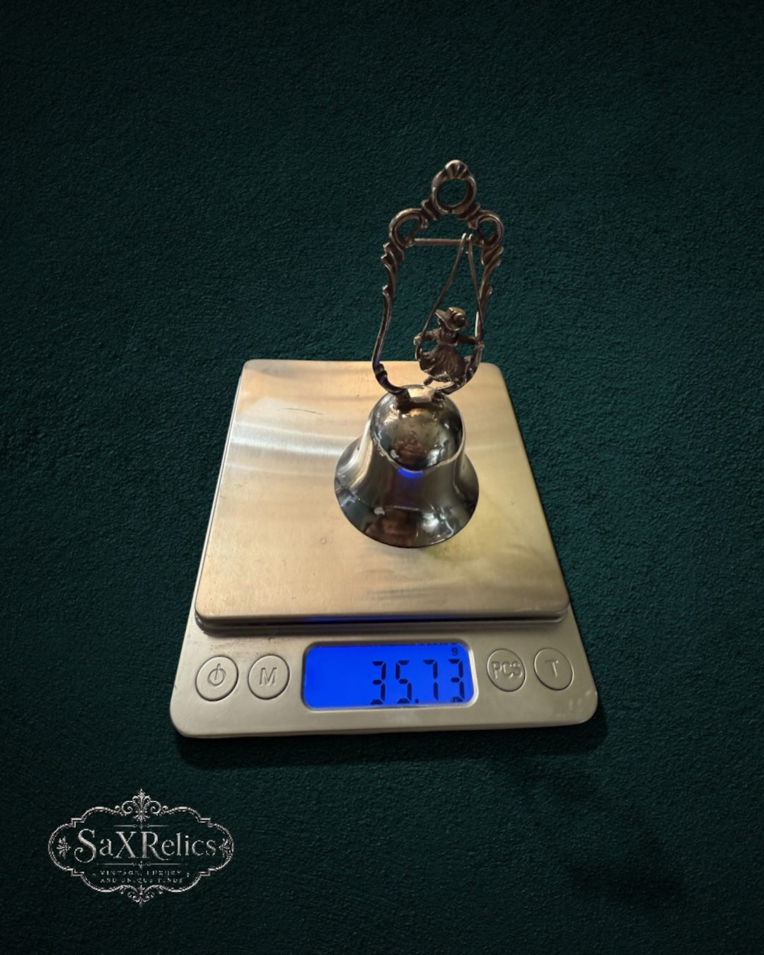 My Store vintage silver-plated figural table bell with a child on a swing design on a digital scale weighing 35.73g