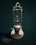 My Store vintage silver-plated table bell featuring a child on a swing inside an ornate scroll-work frame.