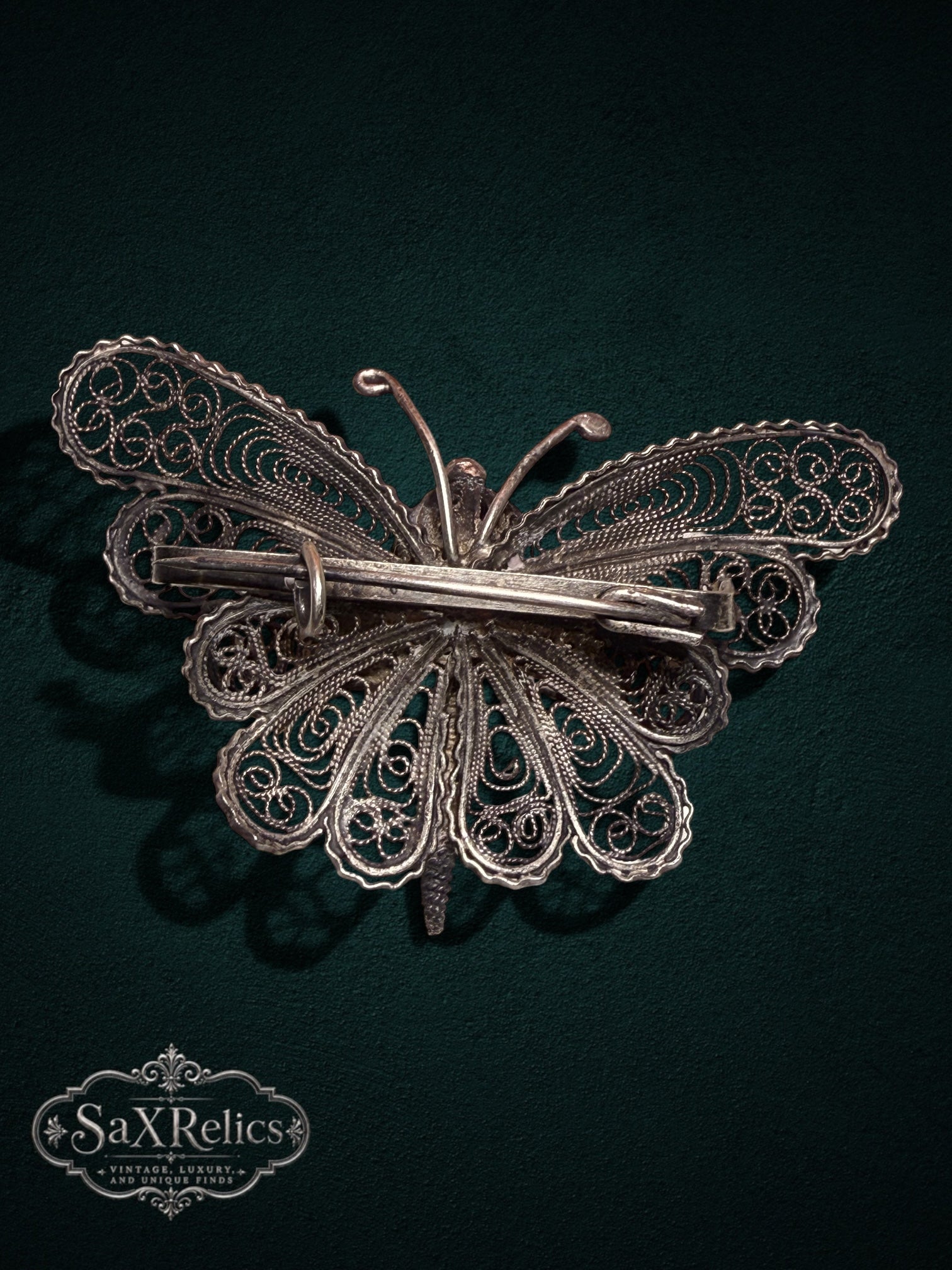 My Store vintage silver filigree butterfly brooch showing the intricate wirework and pin mechanism on the back