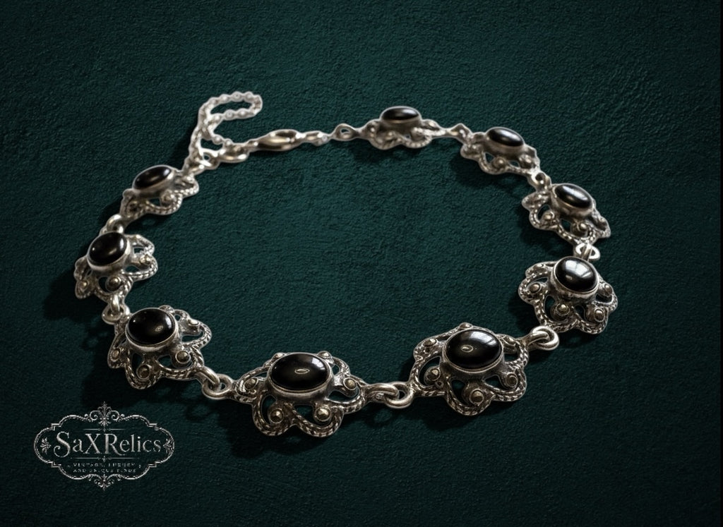 My Store vintage style sterling silver link bracelet featuring ornate floral filigree and polished black onyx stones.