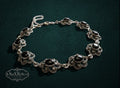 My Store vintage style sterling silver link bracelet featuring ornate floral filigree and polished black onyx stones.