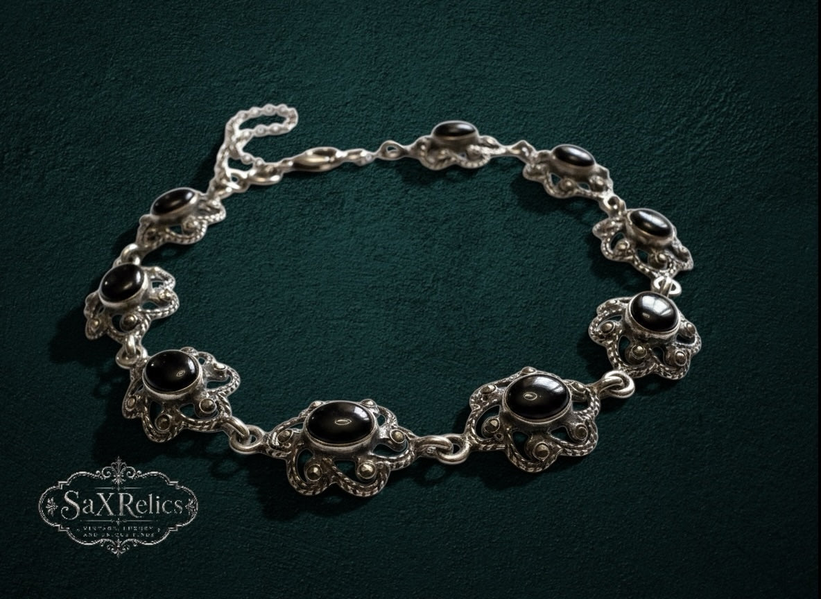 My Store vintage style sterling silver link bracelet featuring ornate floral filigree and polished black onyx stones.
