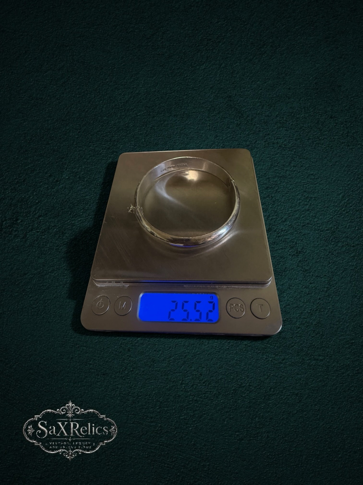 My Store vintage sterling silver hinged bangle bracelet weighing 25.52 grams on a digital scale