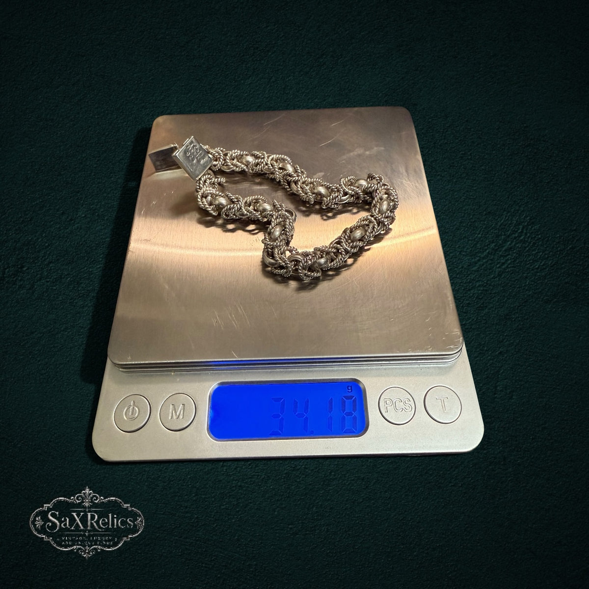 My Store vintage 925 sterling silver woven rope-link bracelet on a digital scale weighing 34.18 grams