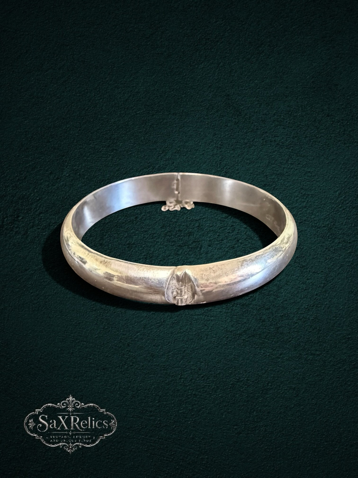 My Store vintage sterling silver hinged bangle bracelet with a polished finish and integrated safety chain.