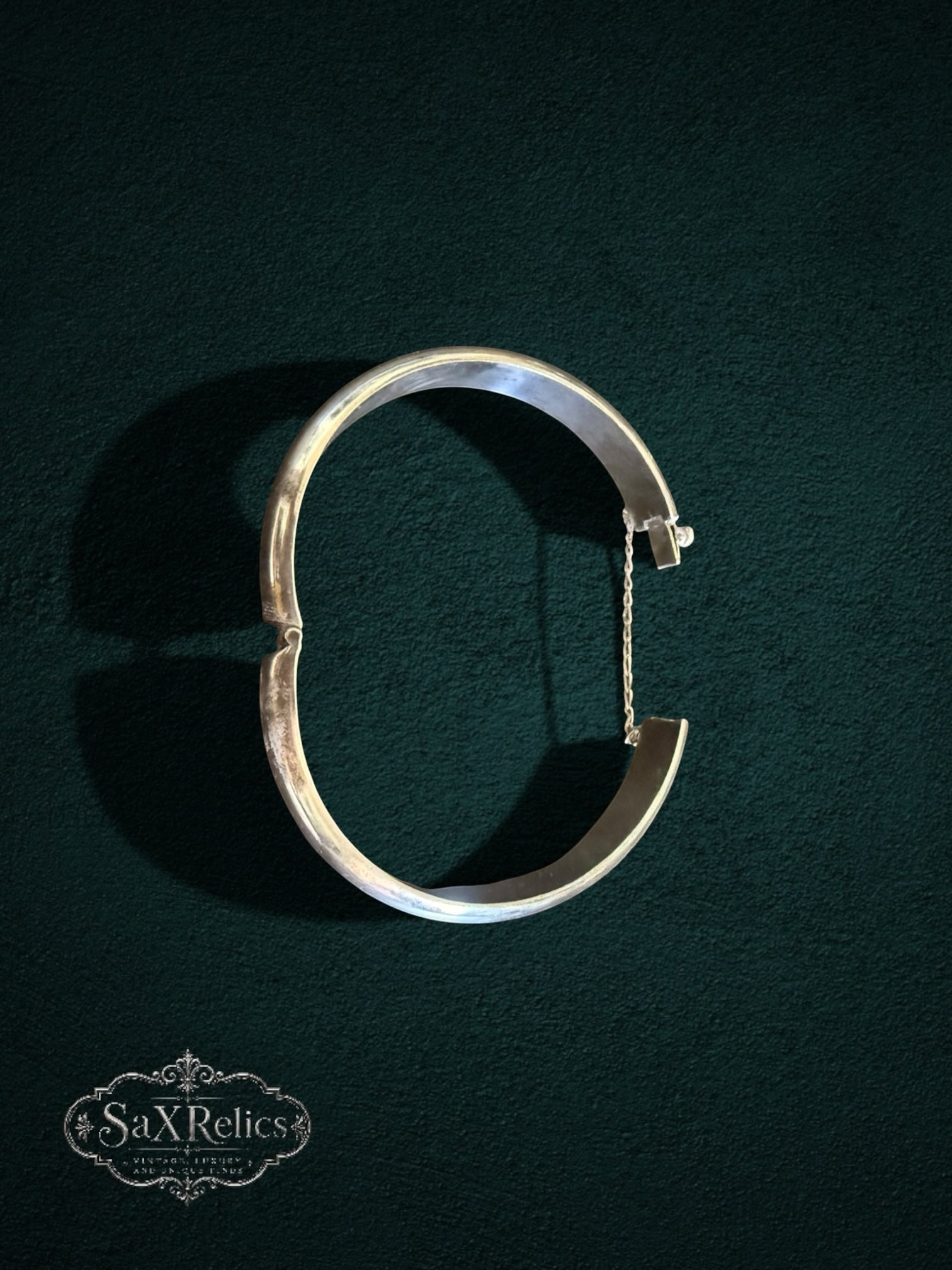 My Store vintage sterling silver hinged bangle bracelet with a polished finish and integrated safety chain.