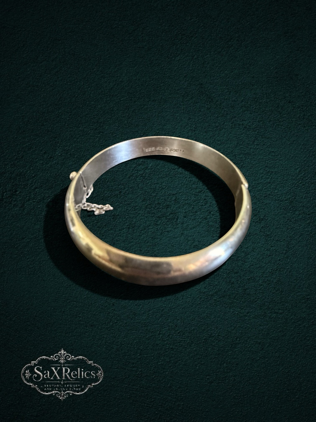 My Store vintage sterling silver hinged bangle bracelet with a polished finish and integrated safety chain.