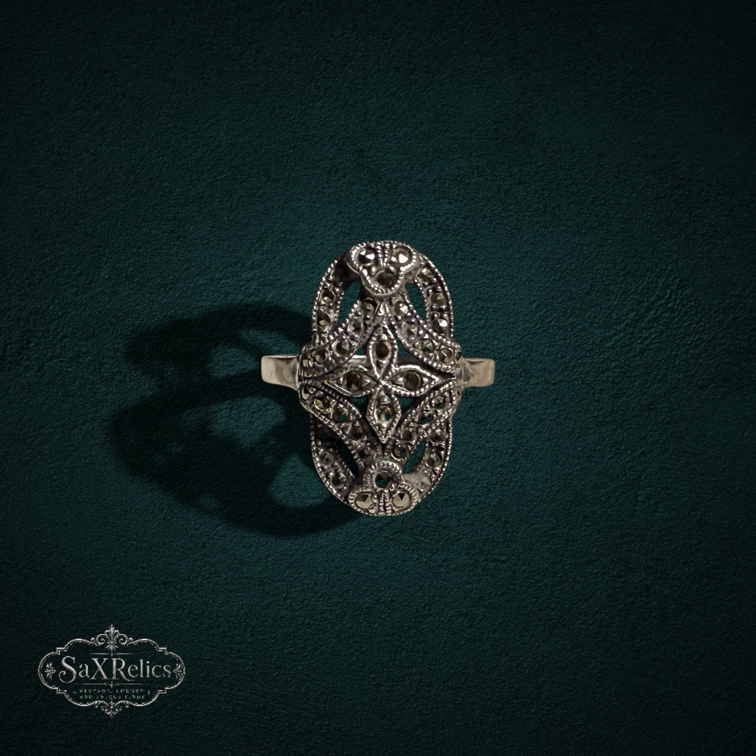 My Store vintage sterling silver ring with an elongated oval face, intricate filigree metalwork, and marcasite stones.
