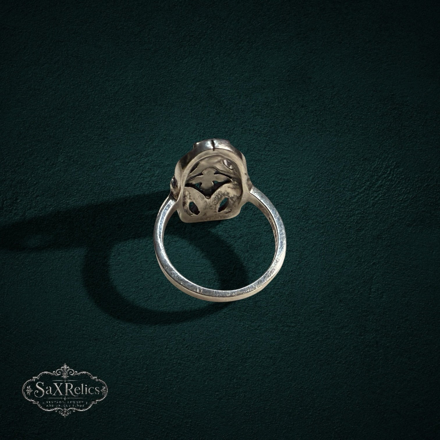 My Store vintage sterling silver ring with intricate filigree metalwork and marcasite stones on a dark background
