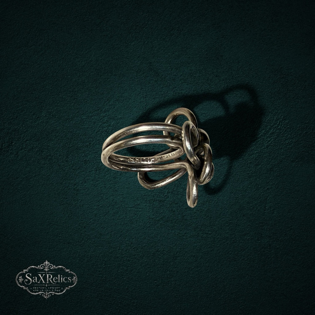 My Store SAXRelics vintage sterling silver statement ring featuring intricate sculptural knotted wirework loops.