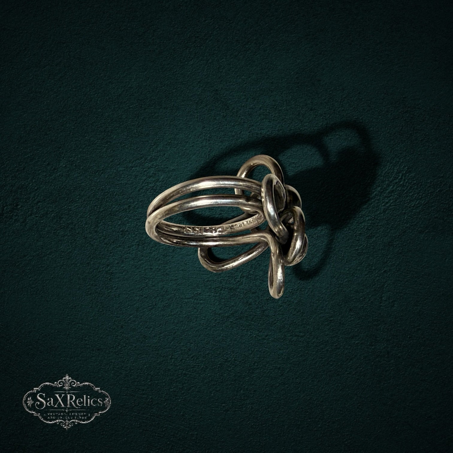 My Store SAXRelics vintage sterling silver statement ring featuring intricate sculptural knotted wirework loops.