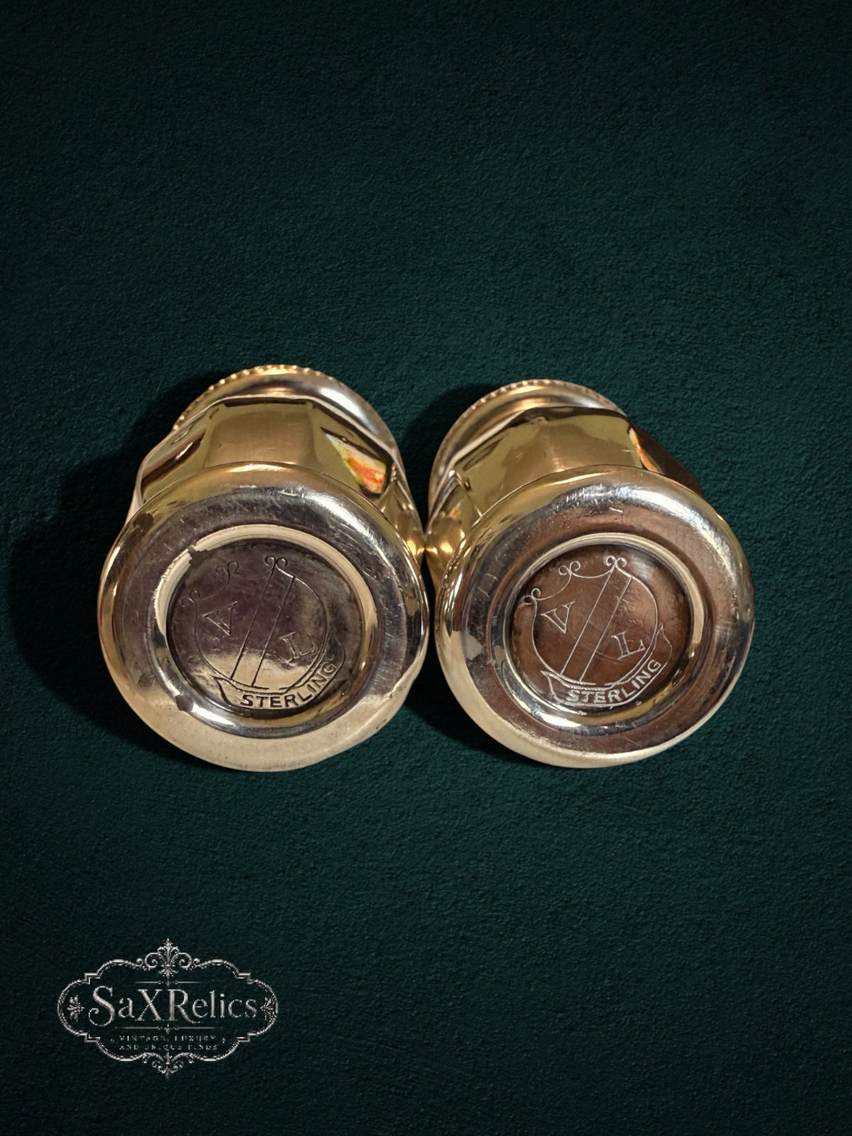 My Store vintage sterling silver salt and pepper shakers with engraved bases on a dark green background