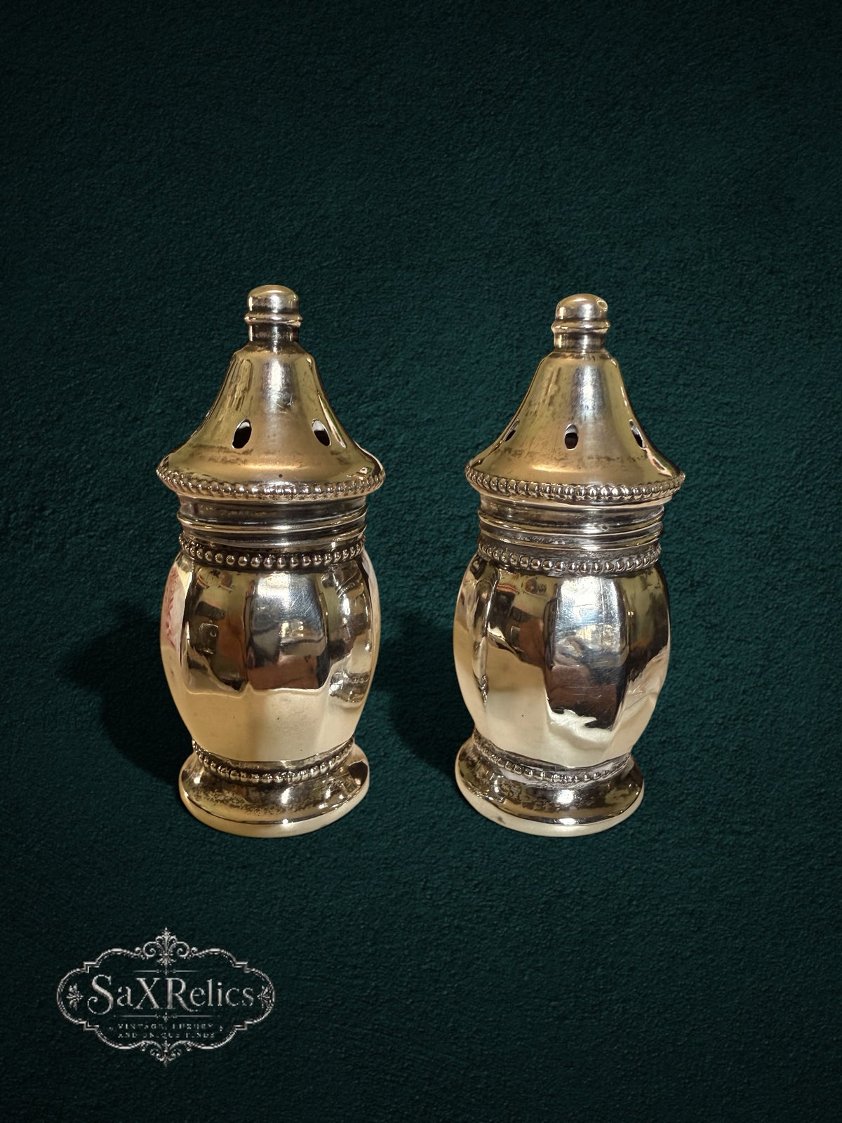 My Store vintage sterling silver salt and pepper shakers with polished finish and intricate beaded base detailing.