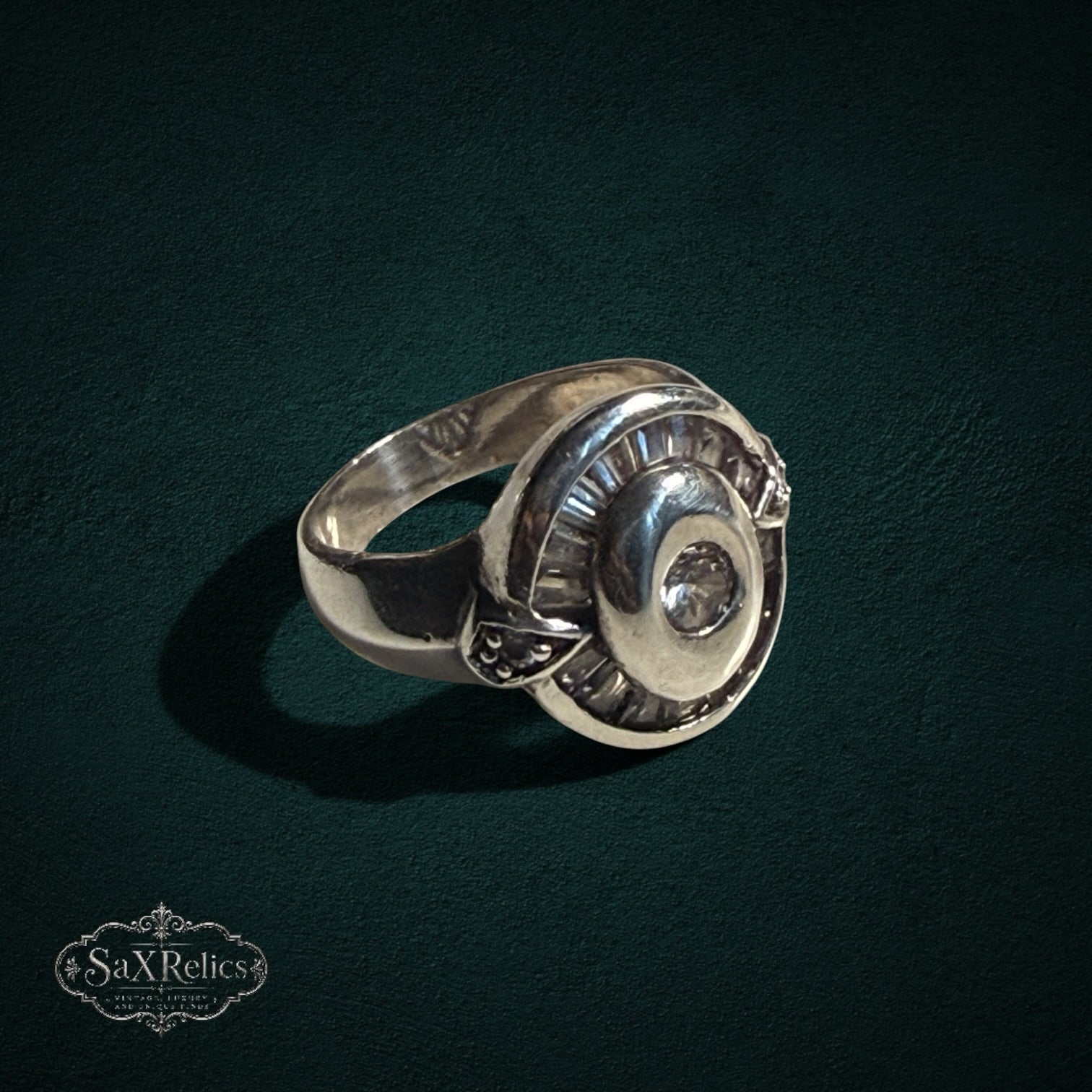 My Store SAXRelics vintage style 925 sterling silver statement ring with a circular halo and baguette-cut stone accents.