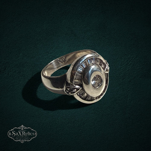 My Store SAXRelics vintage style 925 sterling silver statement ring with a circular halo and baguette-cut stone accents.