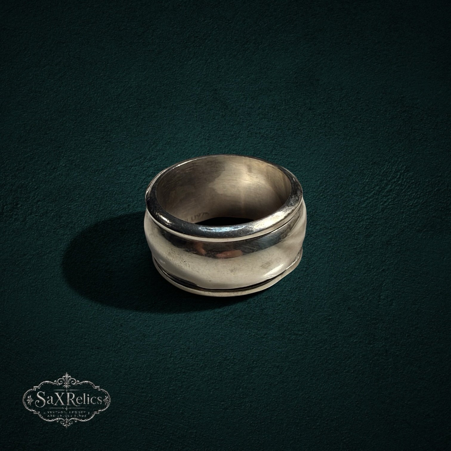 My Store vintage wide band ring in polished sterling silver with a smooth, curved architectural silhouette.