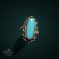 My Store SAXRelics vintage sterling silver ring with an elongated oval turquoise cabochon and intricate filigree detail.