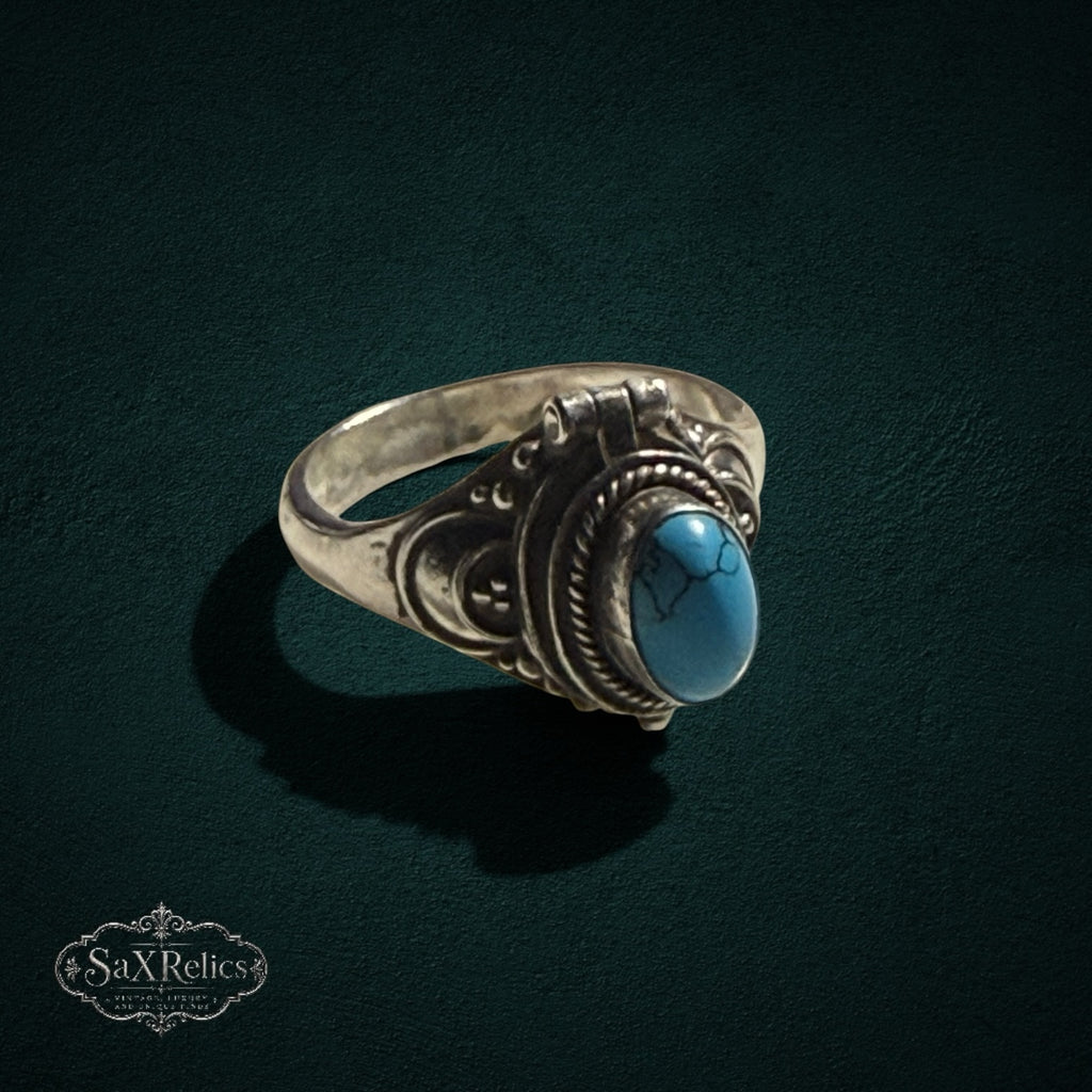 My Store vintage style sterling silver poison ring with a polished turquoise stone and intricate scrollwork detailing.