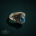 My Store vintage style sterling silver poison ring with a polished turquoise stone and intricate scrollwork detailing.