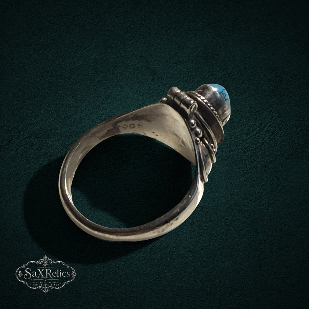 My Store vintage style sterling silver poison ring with a hinged turquoise stone compartment and intricate scrollwork.
