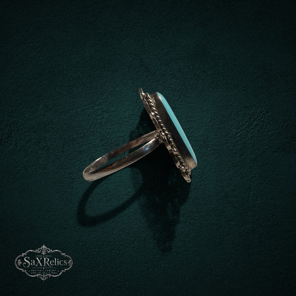 My Store vintage sterling silver ring with oval turquoise cabochon, filigree metalwork, and twisted rope border.