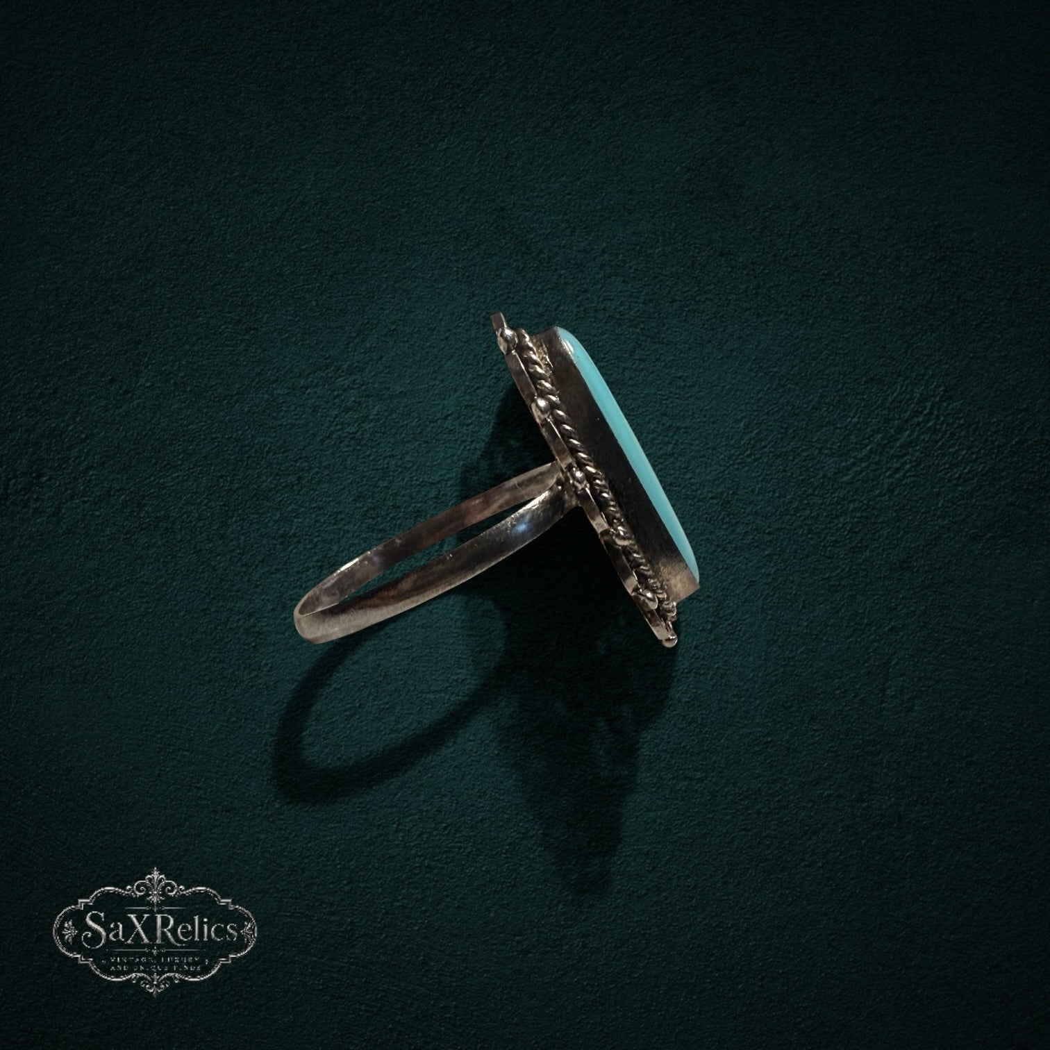My Store vintage sterling silver ring with oval turquoise cabochon, filigree metalwork, and twisted rope border.