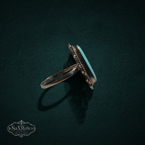 My Store vintage sterling silver ring with oval turquoise cabochon, filigree metalwork, and twisted rope border.