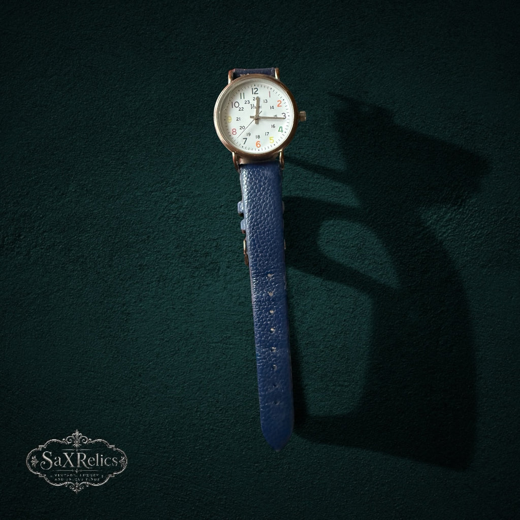 My Store Vivani analog wristwatch with a white dial, multi-colored numerals, gold-tone case, and blue leather strap.