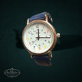My Store Vivani analog wristwatch with a white dial, multi-colored numerals, gold-tone case, and blue leather strap.