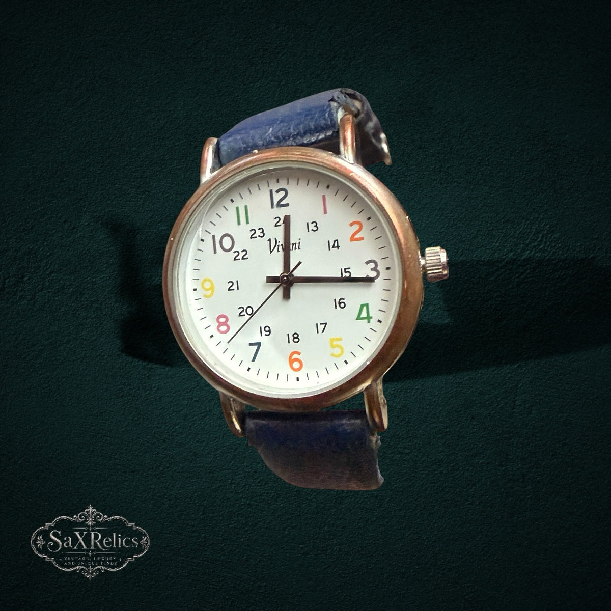 My Store Vivani analog wristwatch with a white dial, multi-colored numerals, gold-tone case, and blue leather strap.