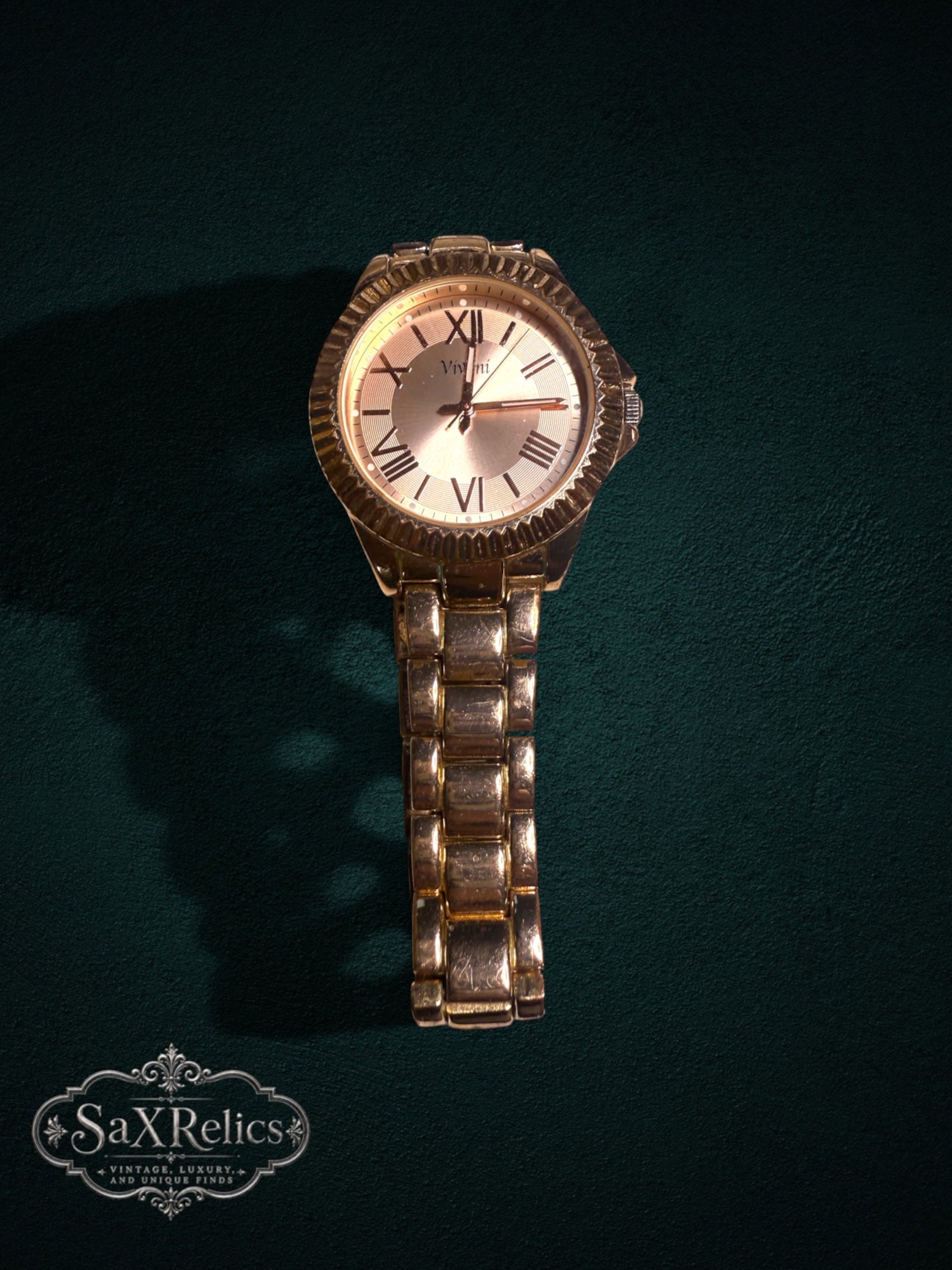 My Store Vivani gold-tone metal link wristwatch with a fluted bezel and Roman numeral dial on a dark green background.