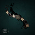 My Store White House Black Market link wristwatch with square glass and black resin accents on a dark green background.