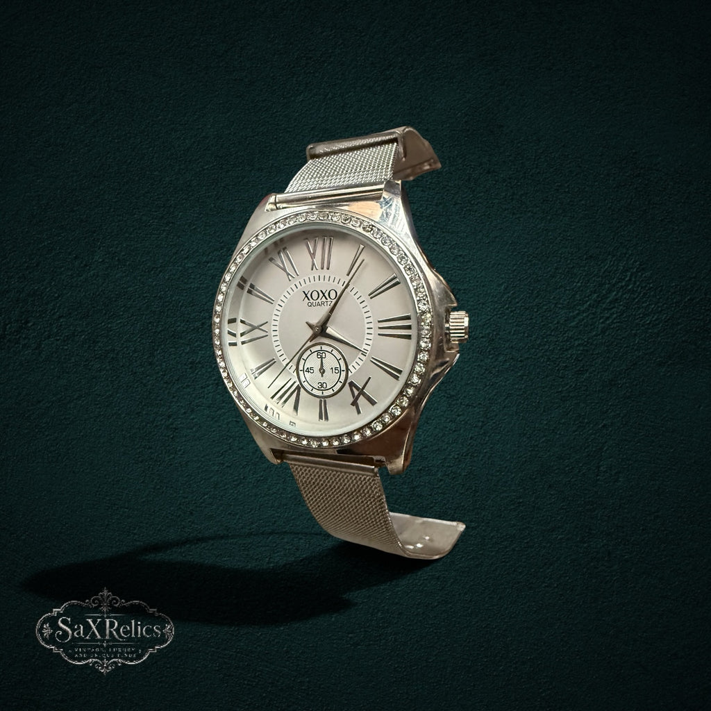 My Store XOXO silver-tone quartz watch with crystal bezel, white dial, Roman numerals, and a comfortable mesh band.